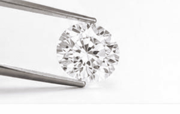 A diamond examined under a loupe at the bench