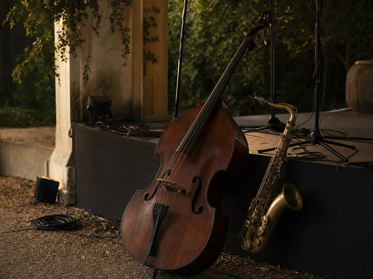A double bass and a saxophone resting against empty stage risers before a set