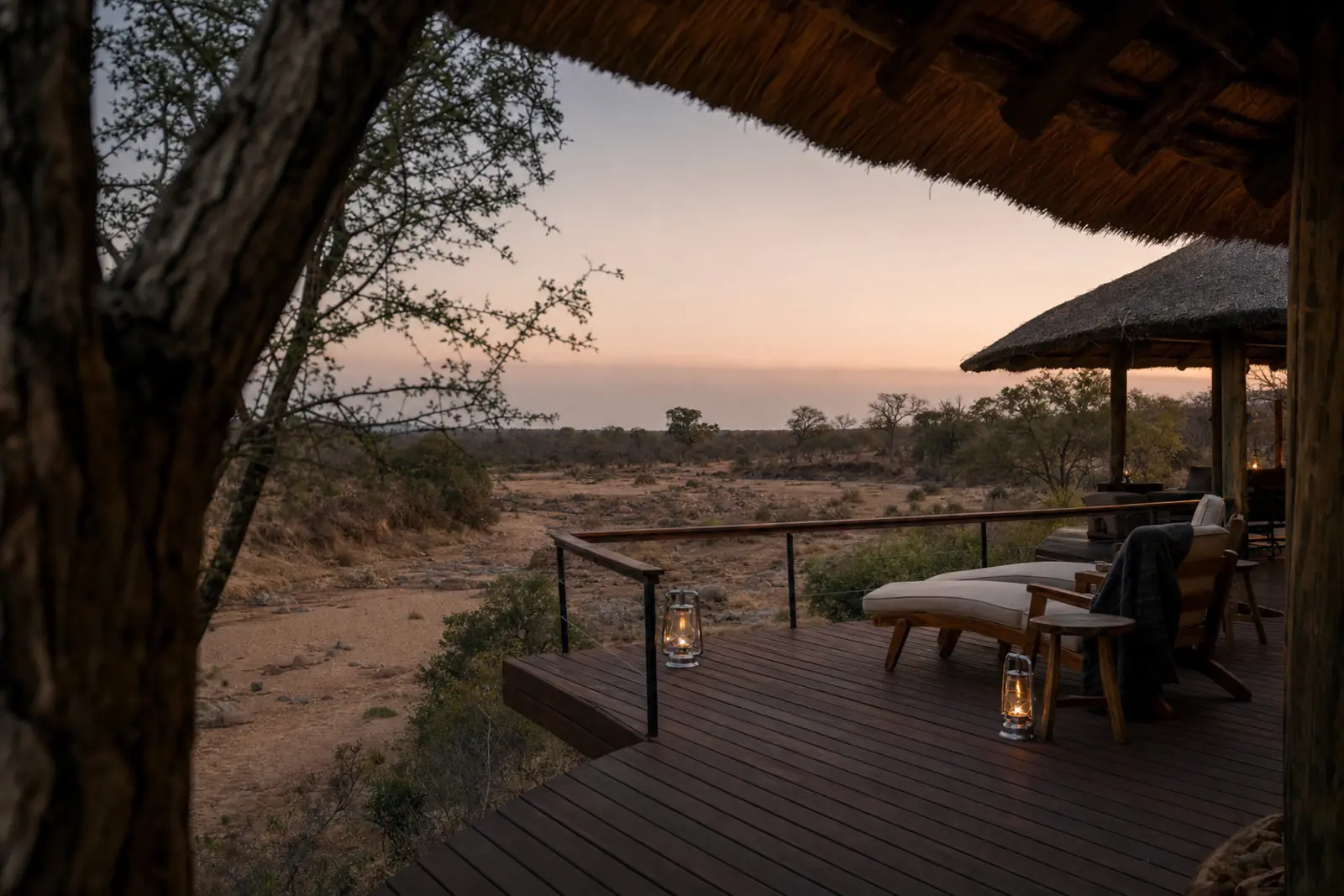 A thatched deck over a dry riverbed in the South African lowveld at dusk