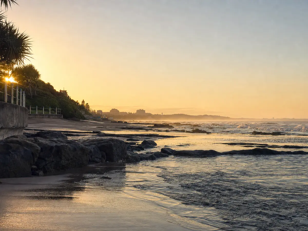 First light on a quiet stretch of KwaZulu-Natal coastline, promenade railing in shadow
