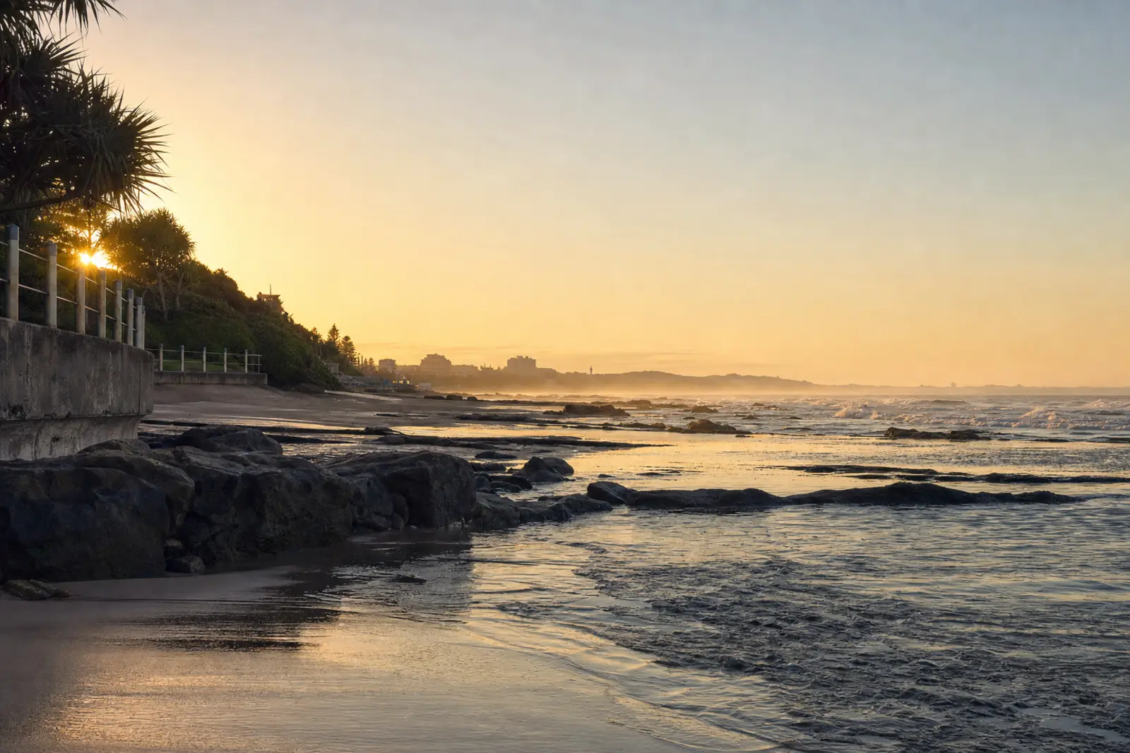 First light on a quiet stretch of KwaZulu-Natal coastline, promenade railing in shadow