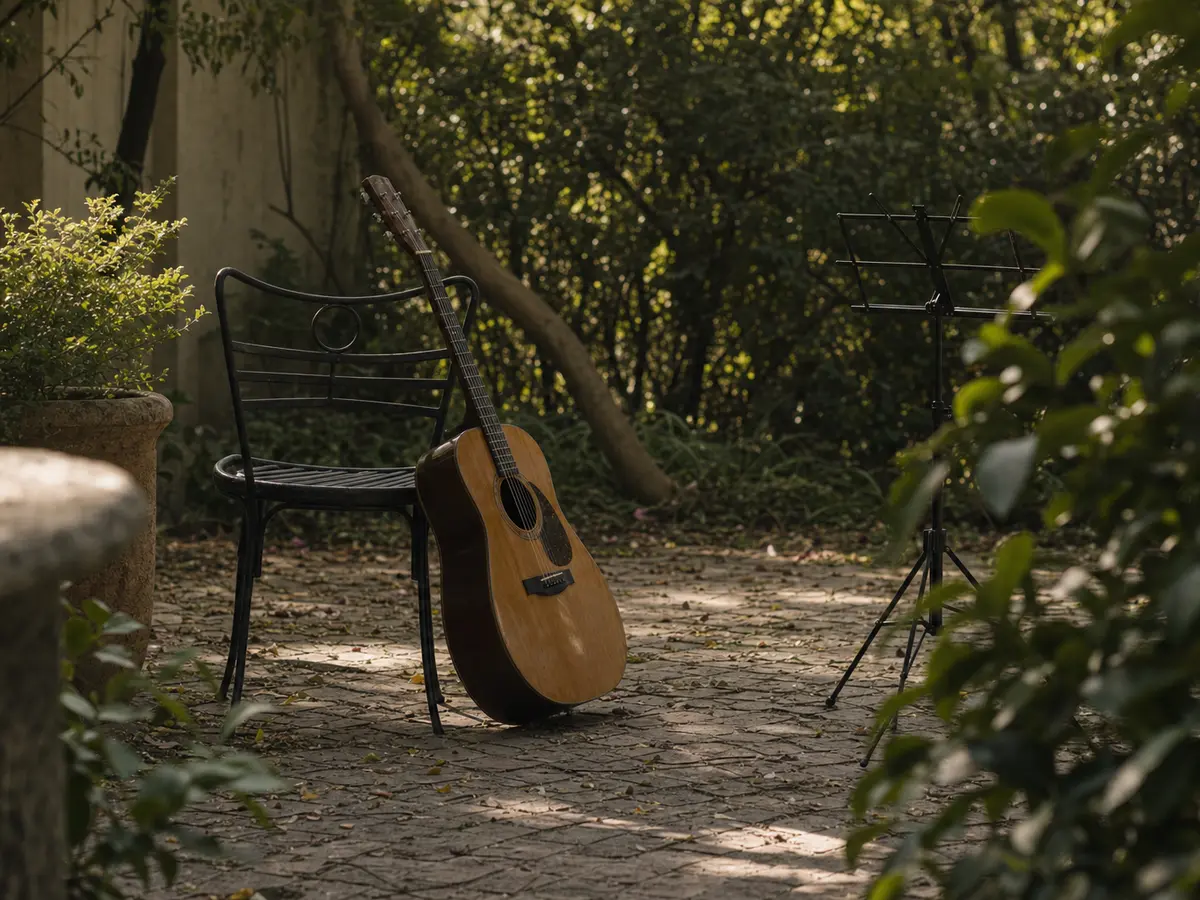 An acoustic guitar leaning against a garden chair beside a folded music stand