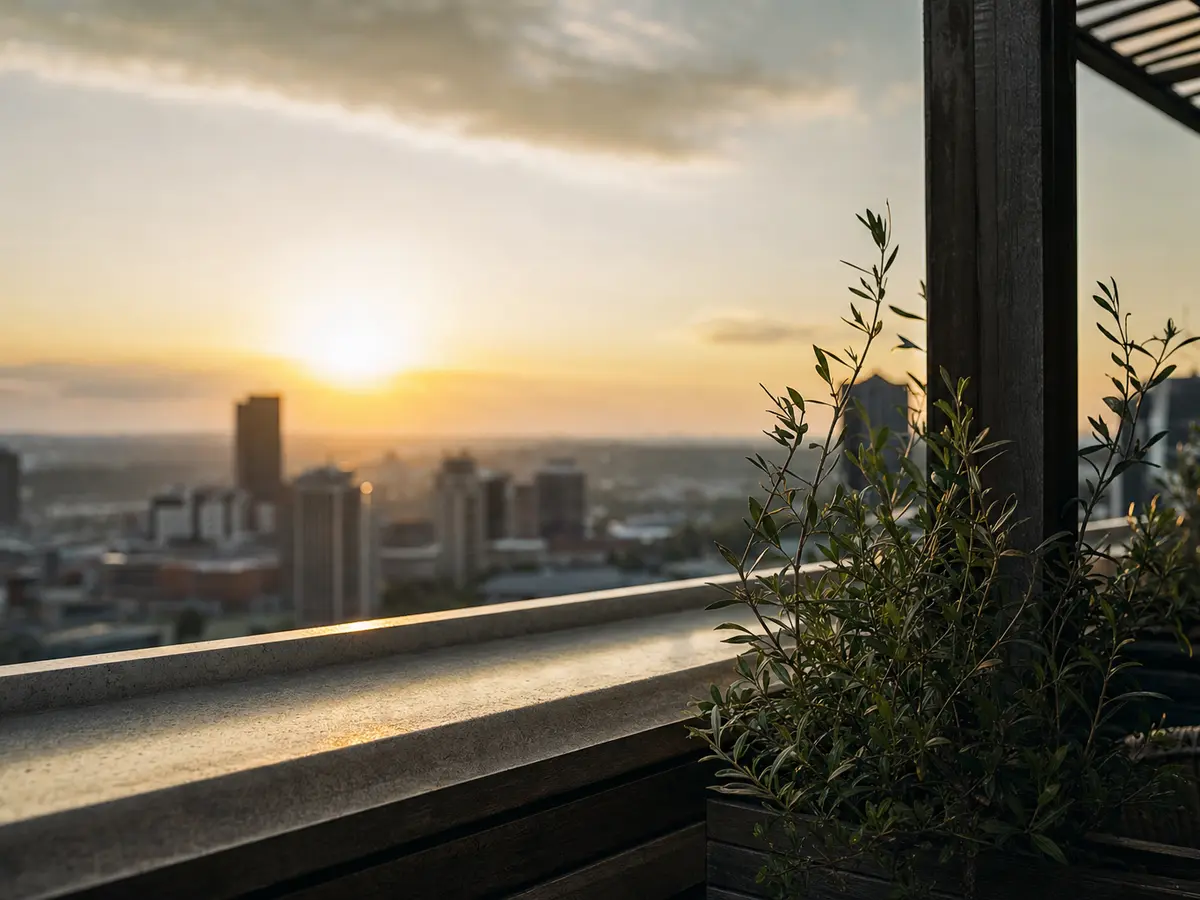 A rooftop terrace at sunset with the city skyline beyond