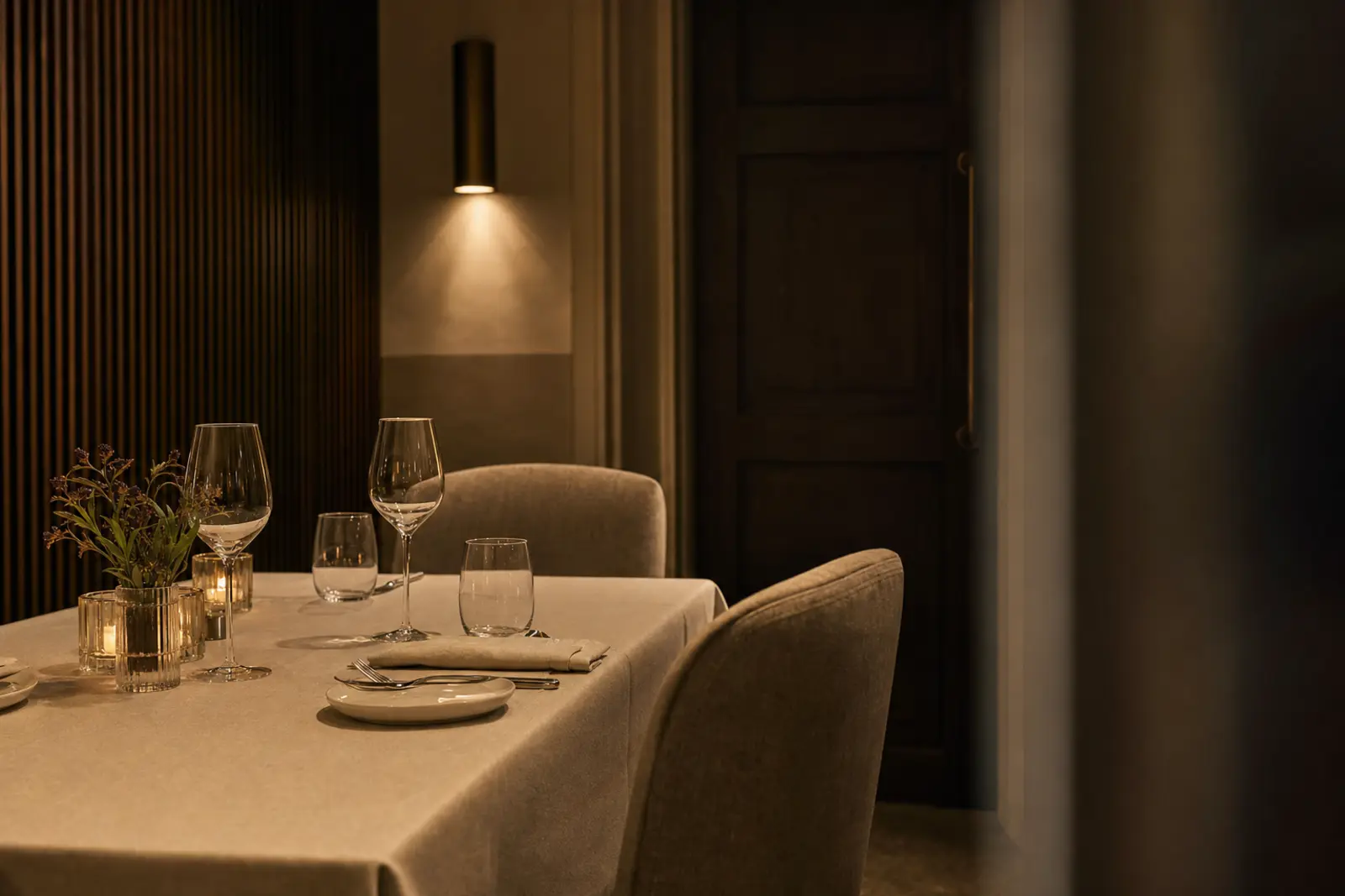 A small private dining room set for two, warm low light