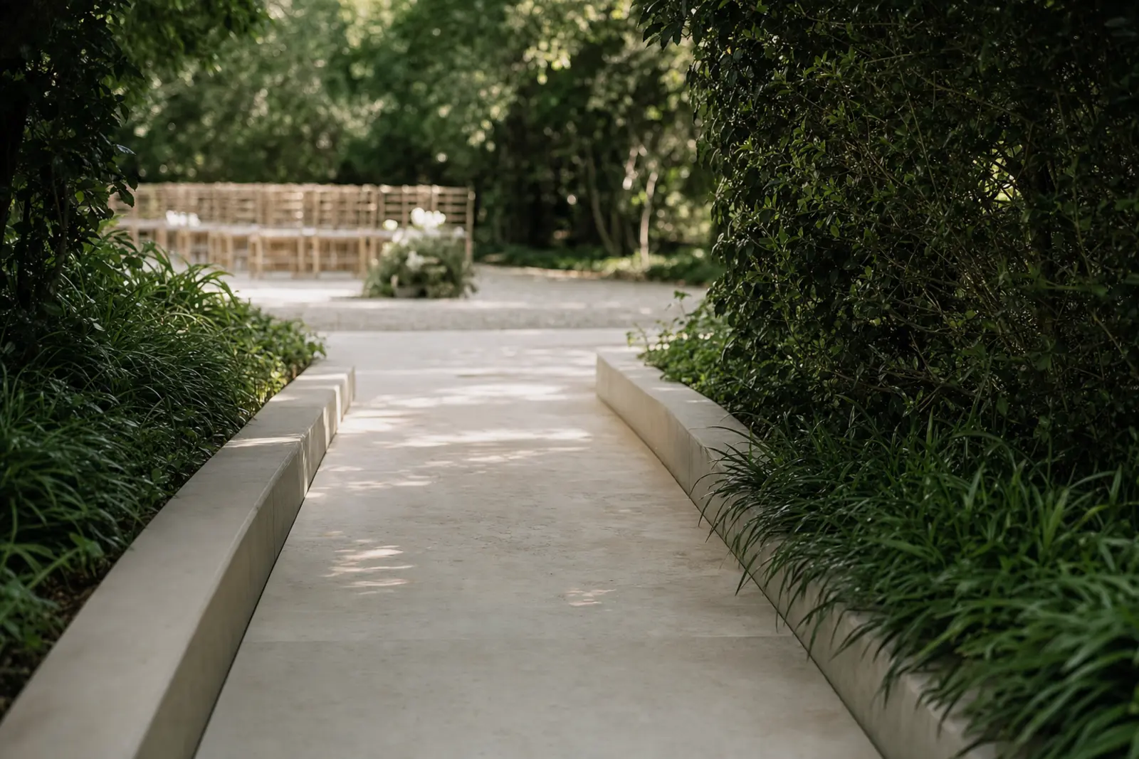A smooth level pathway with a gentle ramp leading toward a garden wedding ceremony area